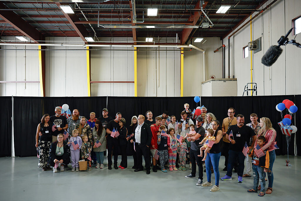 Newly arrived South Africans wait to hear welcome statements from U.S. government officials in a hangar near Washington Dulles International Airport May 12.