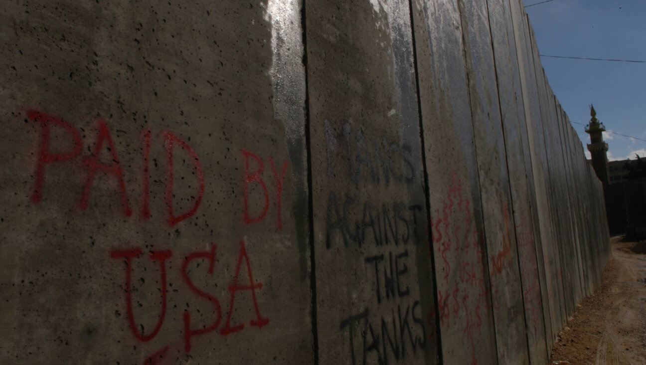 "Paid by USA," is sprayed on the concrete separation wall between the Palestinian city of Abu Dis and Israel.